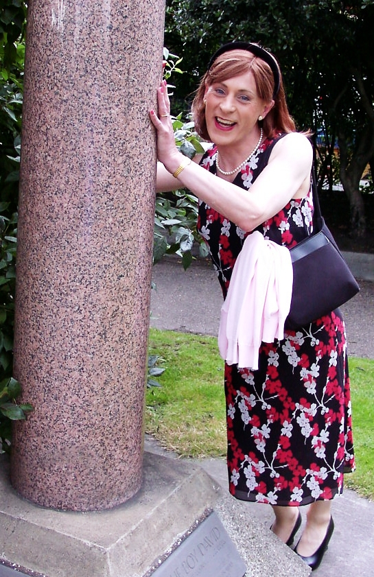 Emma pretends to hold up The Boy David's Pillar