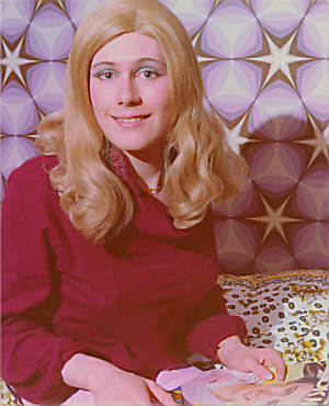 Joy sits on her bed with her teen magazine