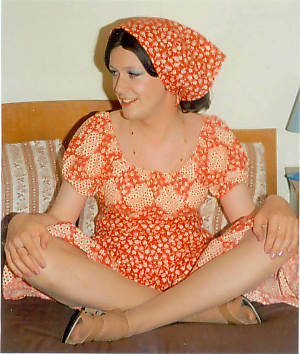Joy cross-legged in her Gypsy dress with matching headscarf