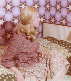 Joy wears an ethnic jumper and matching skirt with broderie anglaise trim