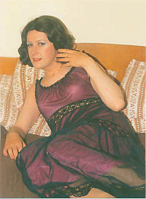 Joy on the bed in her mauve nightie