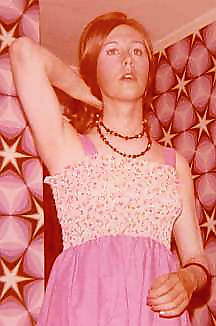 Joy's right arm holds her hair back